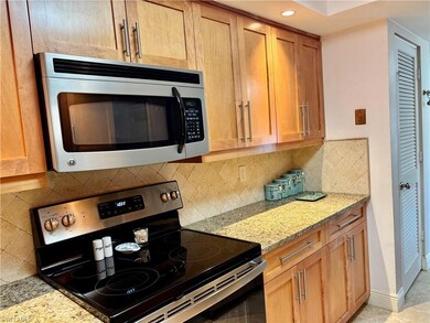 Kitchen featuring tasteful backsplash, light stone