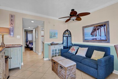 Living room featuring ceiling fan, light tile patt