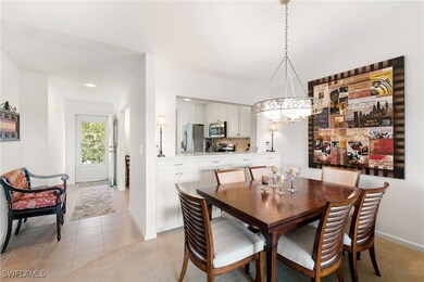 Dining space with light tile patterned floors and light carpet