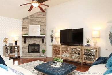 Stacked stone fireplace and vaulted ceiling with n