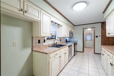 Kitchen with sink, a textured ceiling, tasteful ba