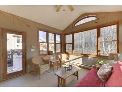 The 4 season porch features a vaulted ceiling with