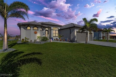 View of front of home featuring a yard and a garag
