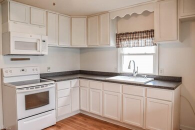 The kitchen has an oven/range and microwave.