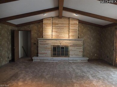 Great room with vaulted ceiling and stone fireplace.