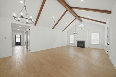 Open dining area and great room with fireplace (*Photo not of actual home and used for illustration purposes only.)