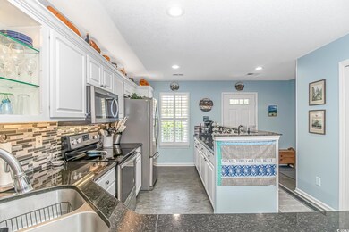 Kitchen featuring decorative backsplash, stainless