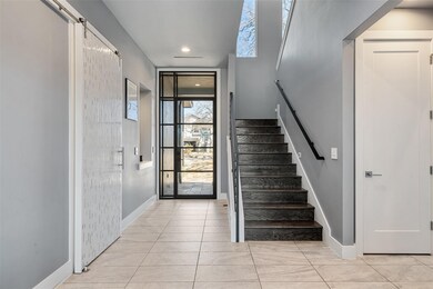 Entryway with stairway, recessed lighting, and ba