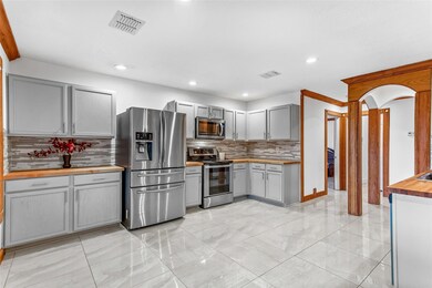 Kitchen featuring visible vents, gray cabinets, ap