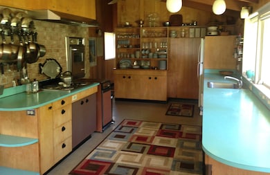 Kitchen featuring light countertops, decorative backsplash, and oven