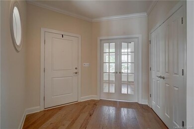 Lovely foyer with architectural window and french 