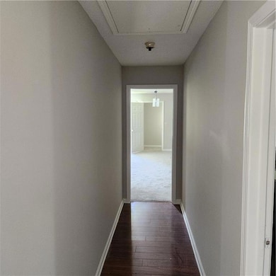 Corridor featuring dark hardwood / wood-style floo