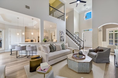 Living room with arched walkways, visible vents, 