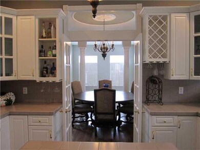 Kitchen. Access the dining room through the French doors.
