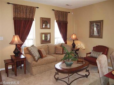 Living Room. Pretty as a model!  The custom drapes do remain...lucky for you.  Nice neutral paint colors and lots of natural light.