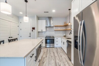 Kitchen featuring appliances with stainless steel