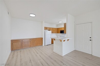 Kitchen featuring freestanding refrigerator, black