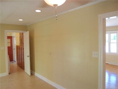 View of carport entrance, laundry area, and front living room