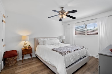 Bedroom with light wood-style flooring, baseboard