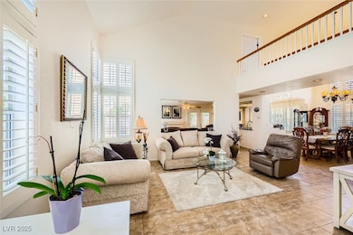 Living room featuring high vaulted ceiling, a chan