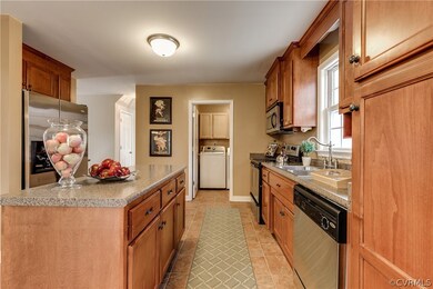 View of kitchen into laundry room with cabinetry