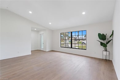 Unfurnished room with recessed lighting, baseboards, light wood finished floors, and lofted ceiling