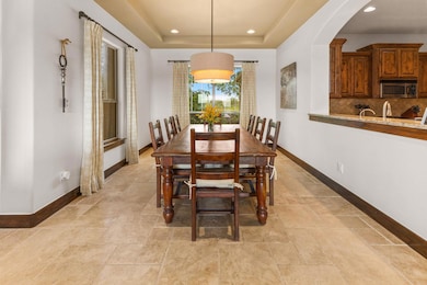 Dining space with baseboards, arched walkways, re