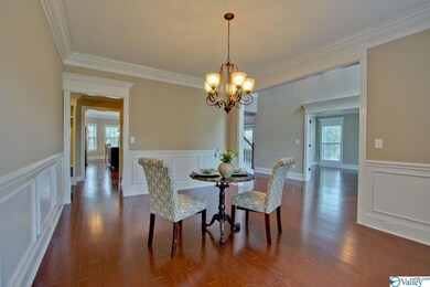 boasts beautiful hardwoods, crown molding, wainscotting, and a timeless chandelier.