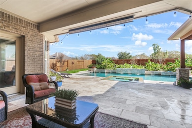 Enjoy outdoor living in this inviting covered patio, perfect for relaxation and entertaining.