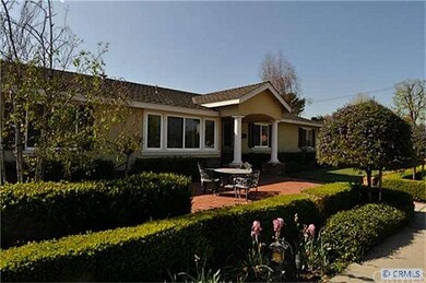 FRONT YARD WITH MULTIPLE FLOWER BEDS