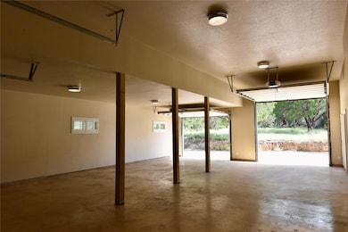 The garage itself is a showstopper, with four bay doors, tons of space, and clearance tall enough to potentially accommodate a full-size RV.