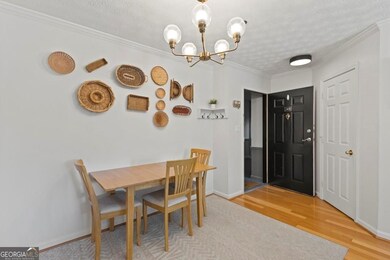 Dining space with baseboards, wood finished floors, and a chandelier