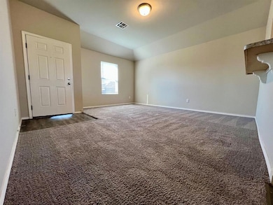 Empty room with dark carpet and baseboards