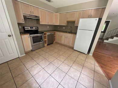 Kitchen featuring light brown cabinets, tasteful 