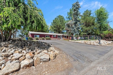 Ranch-style home with asphalt driveway and a metal roof