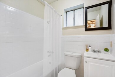 Bathroom with vanity, shower / bath combo with sh