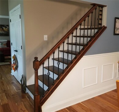 Split staircase featuring wrought iron spindles an