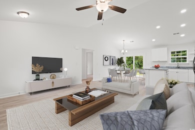 Living room featuring lofted ceiling, recessed lighting, light wood-style flooring, and ceiling fan