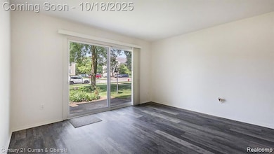 Unfurnished room with dark wood-type flooring