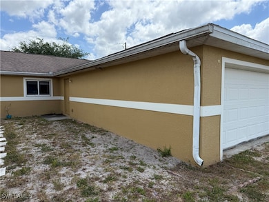 View of side of property with stucco siding and a