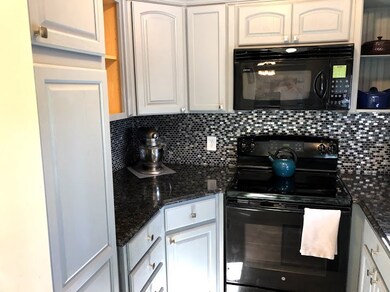 Kitchen with gorgeous black splash and newer appli