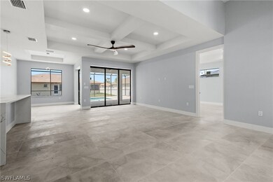 Unfurnished living room with beam ceiling, coffere