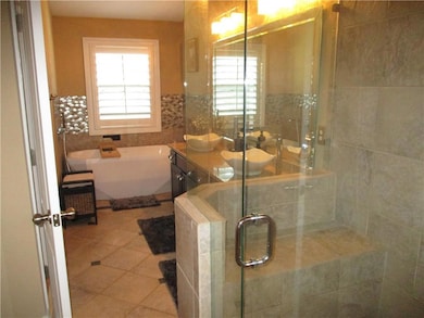 Bathroom with tile patterned floors, plenty of nat