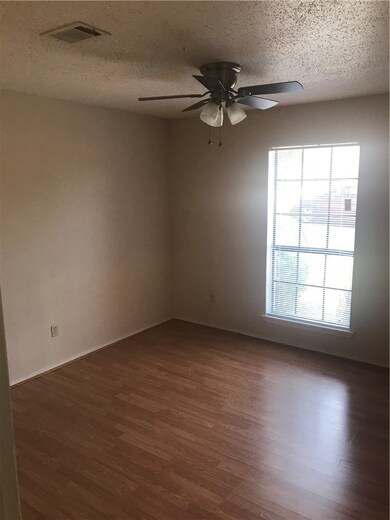Unfurnished room featuring a textured ceiling, cei