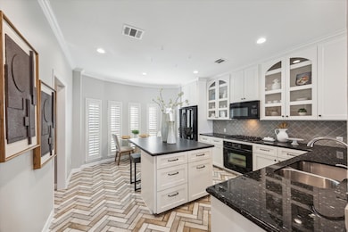 This kitchen features a modern design with white c