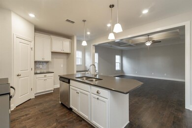 Kitchen, great room, dining room.  Similar home.