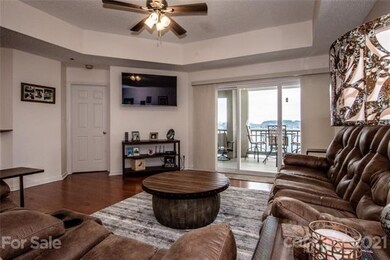 Living room w/ sliding doors to balcony w/ waterfr
