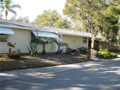 Side of house showing another entry door and carpo