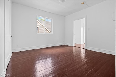 Empty room with dark wood-style floors
