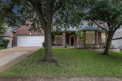 View of front facade with brick siding, concrete 